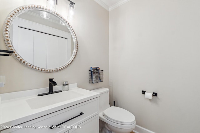 bathroom featuring toilet, crown molding, and vanity