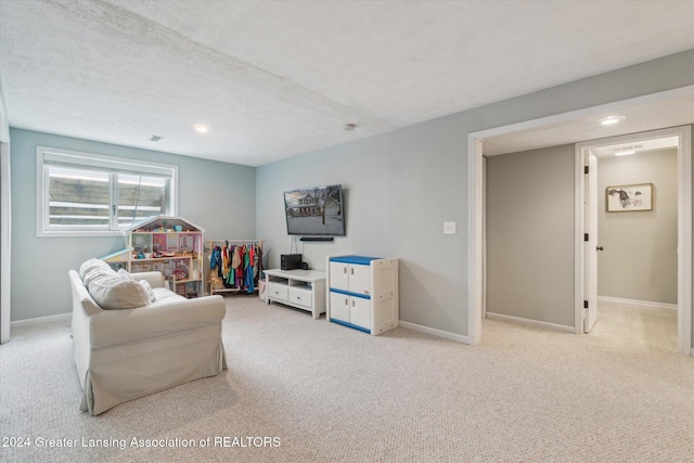 carpeted living room featuring a textured ceiling