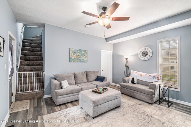 living room featuring ceiling fan, plenty of natural light, and wood-type flooring