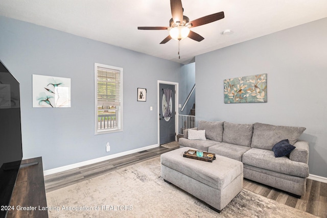 living room featuring hardwood / wood-style floors and ceiling fan