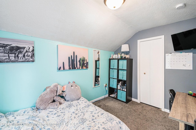 carpeted bedroom with a textured ceiling and lofted ceiling