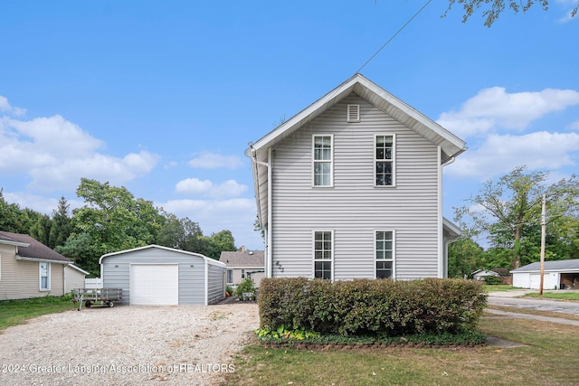 view of home's exterior with a garage and an outdoor structure