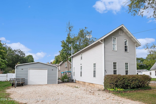 view of side of property with a garage and an outdoor structure