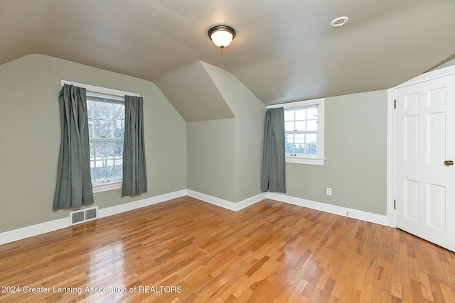 bonus room with vaulted ceiling and hardwood / wood-style flooring