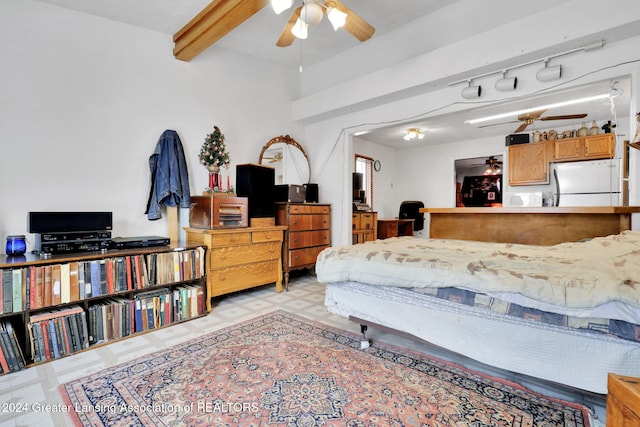 bedroom featuring ceiling fan, white fridge, and beamed ceiling