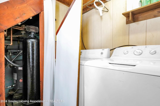 laundry area featuring washer / clothes dryer and wooden walls