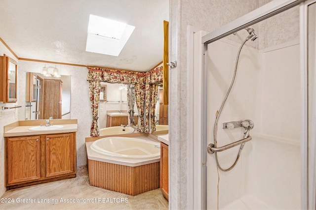 bathroom with ornamental molding, separate shower and tub, vanity, and a skylight