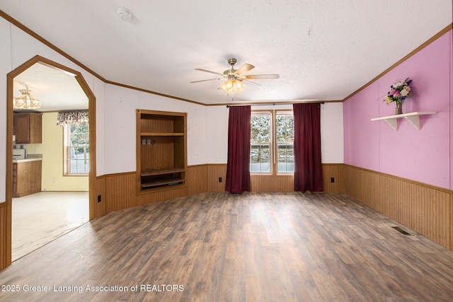 unfurnished living room featuring lofted ceiling, hardwood / wood-style flooring, and a healthy amount of sunlight