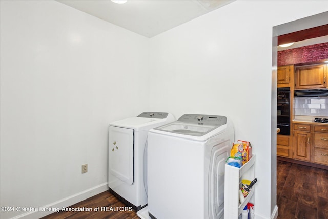 washroom featuring dark wood-type flooring and washer and clothes dryer