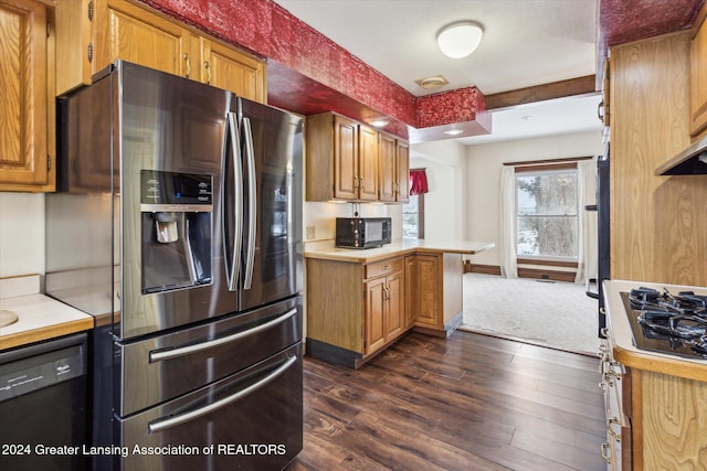 kitchen with black appliances and dark hardwood / wood-style floors