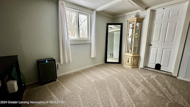 unfurnished bedroom with beam ceiling, carpet floors, and ornamental molding