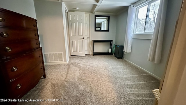 interior space featuring light carpet, beamed ceiling, and coffered ceiling