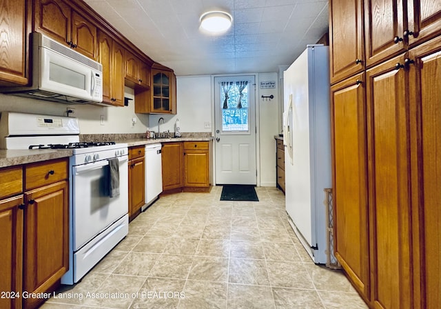 kitchen featuring white appliances and sink