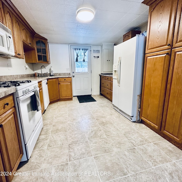 kitchen featuring white appliances and sink