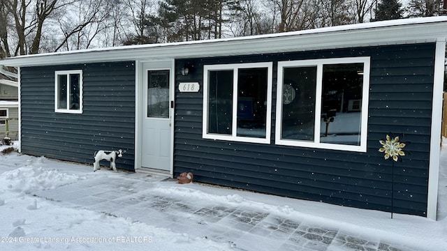 view of snow covered property entrance