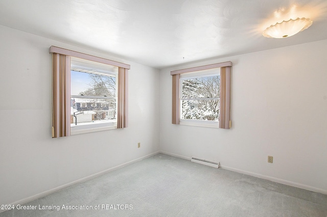 unfurnished room with carpet floors, a baseboard radiator, and baseboards