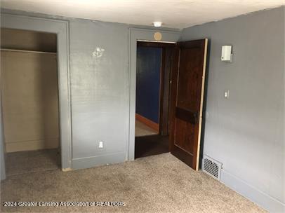 unfurnished bedroom with a closet and carpet