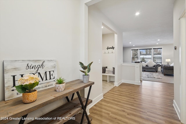 corridor with hardwood / wood-style flooring