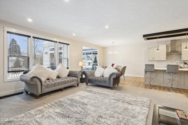 living room featuring light hardwood / wood-style flooring and a notable chandelier