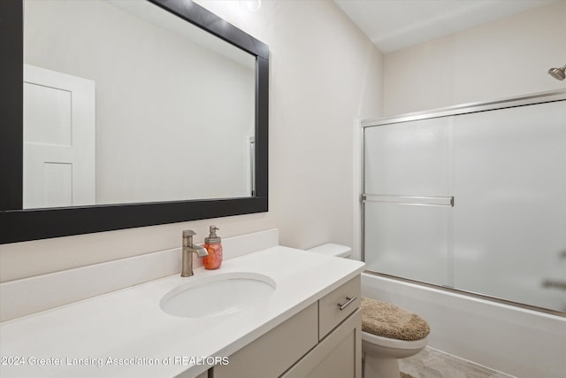 full bathroom with toilet, combined bath / shower with glass door, and vanity