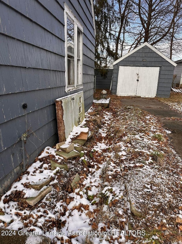 yard covered in snow featuring a shed