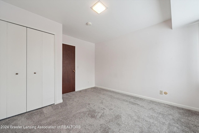 unfurnished bedroom featuring a closet and carpet floors