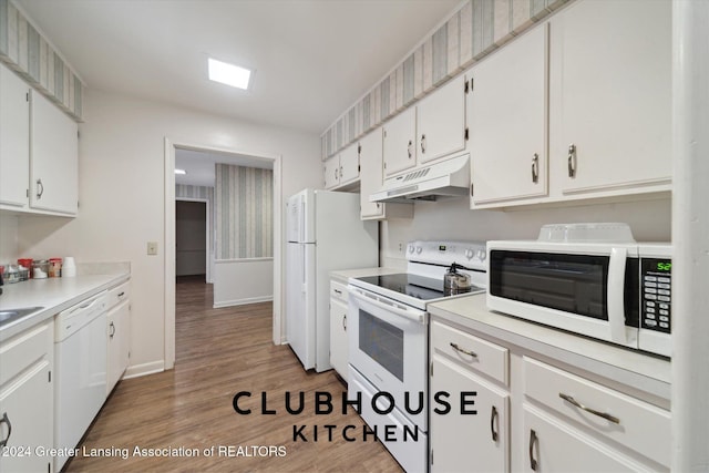 kitchen featuring hardwood / wood-style floors, white cabinets, and white appliances