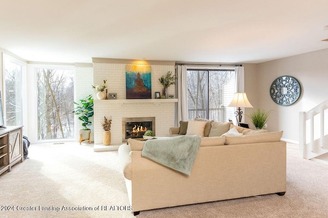 carpeted living room with a brick fireplace