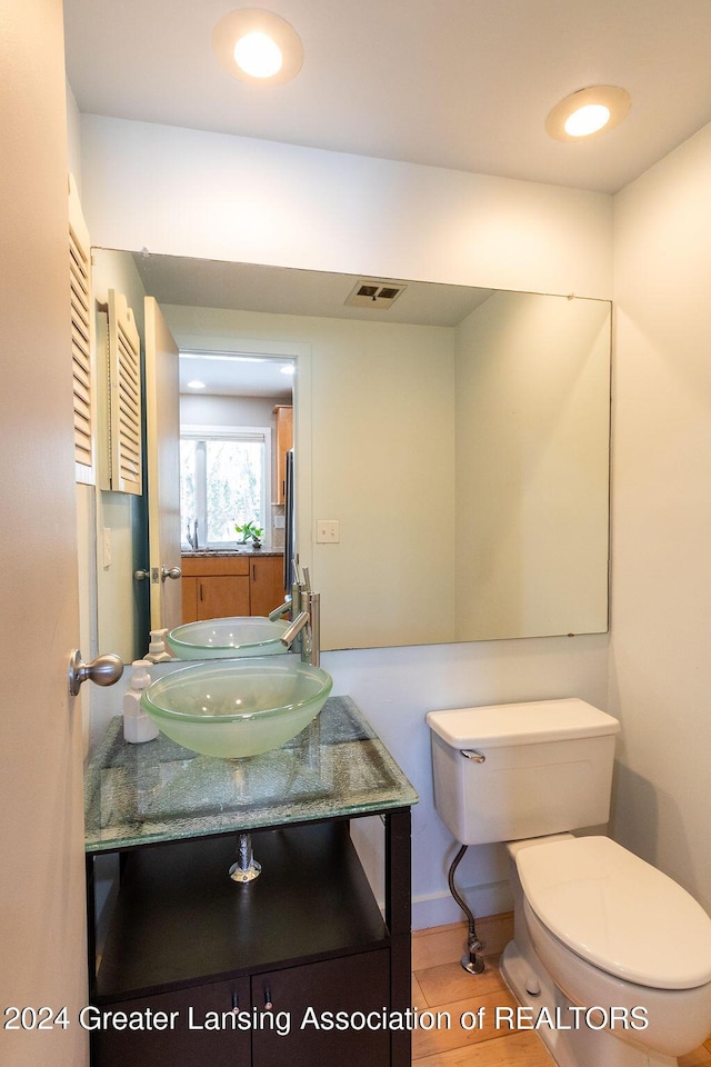 bathroom featuring toilet, vanity, and tile patterned floors