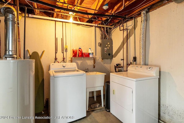 washroom with water heater, electric panel, and separate washer and dryer