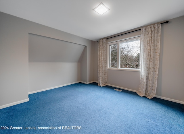 bonus room featuring carpet floors and vaulted ceiling