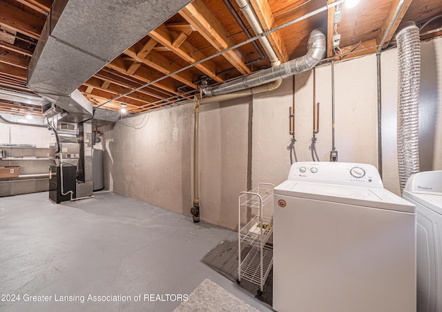 basement featuring washer and dryer and heating unit