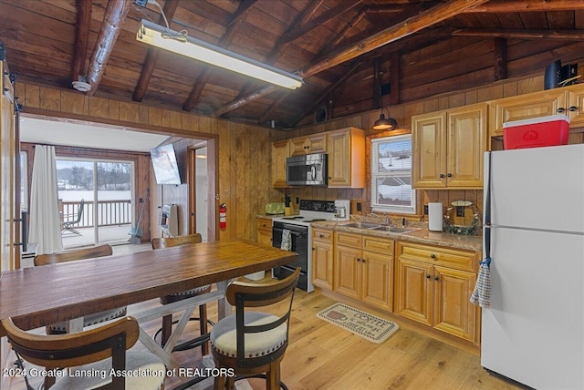 kitchen featuring electric range, white refrigerator, wooden walls, and sink