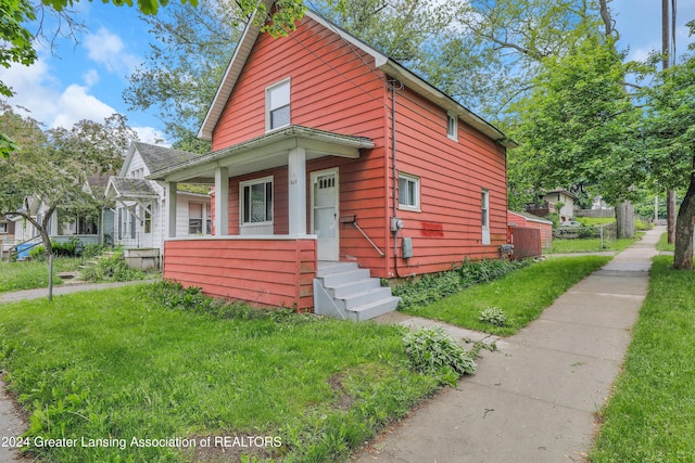 bungalow-style house featuring a porch and a front yard