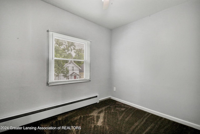 carpeted empty room with a baseboard heating unit and ceiling fan