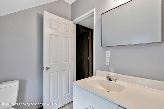 bathroom with tile patterned floors, vanity, and toilet