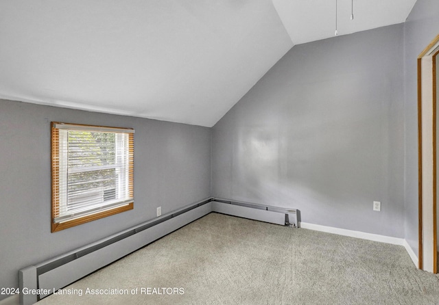 interior space with baseboard heating, lofted ceiling, and carpet flooring