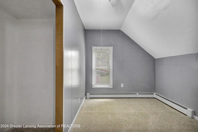 additional living space featuring lofted ceiling, carpet flooring, and baseboard heating