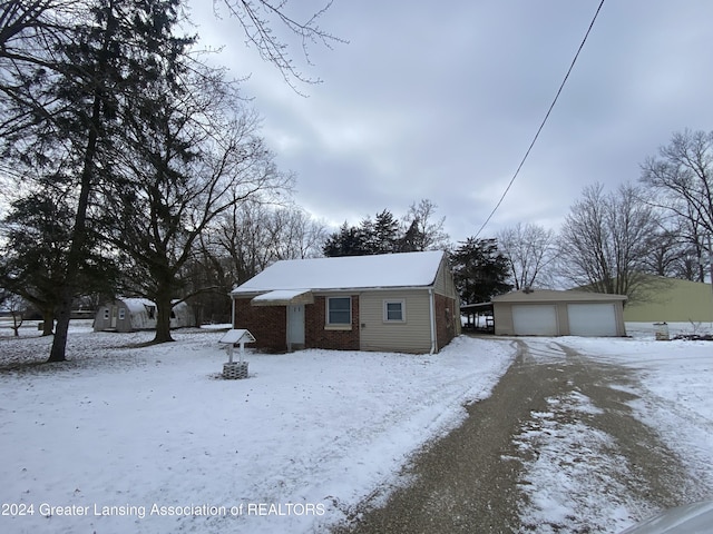 view of front of property with a garage and an outdoor structure