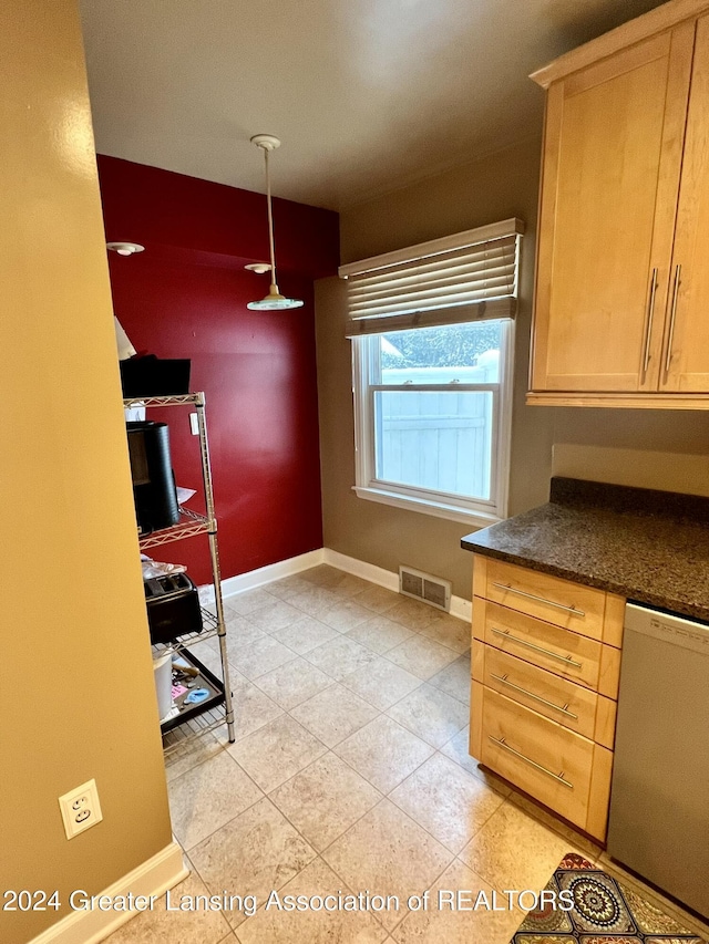 kitchen with white dishwasher, decorative light fixtures, and light brown cabinetry