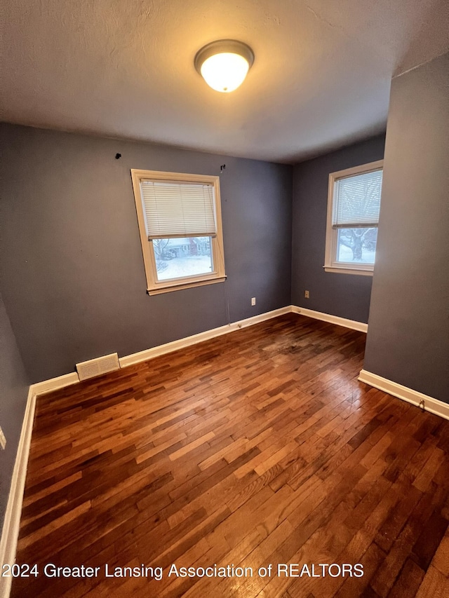 spare room with hardwood / wood-style floors