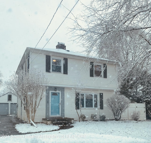 view of front of property featuring a garage and an outdoor structure