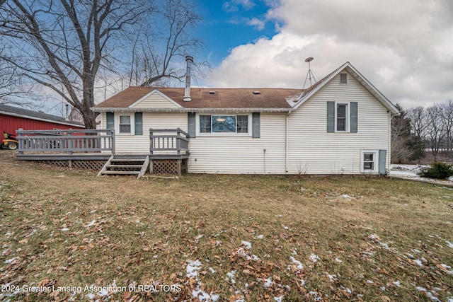 rear view of house with a yard and a wooden deck