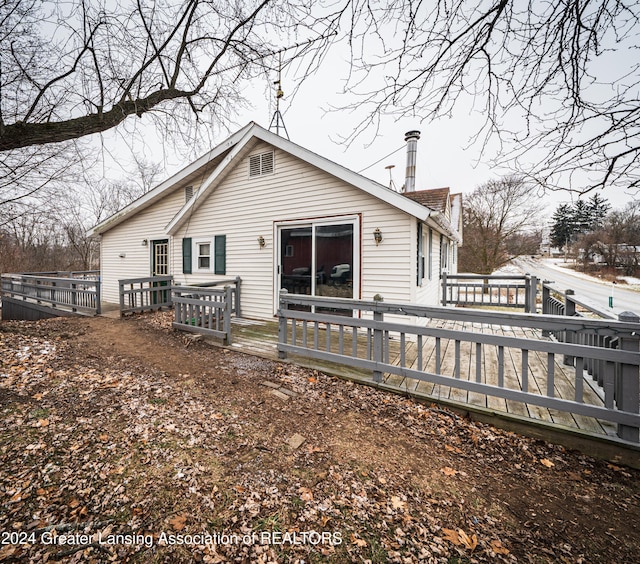 rear view of house featuring a wooden deck