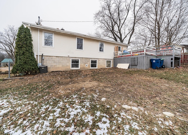 snow covered house with central air condition unit