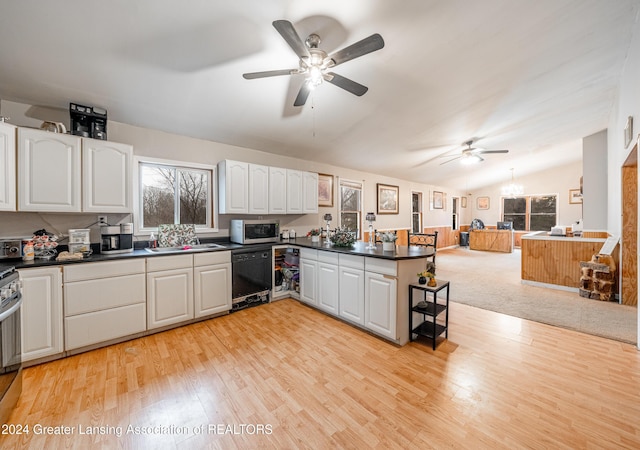 kitchen featuring kitchen peninsula, stainless steel appliances, light hardwood / wood-style floors, lofted ceiling, and white cabinetry