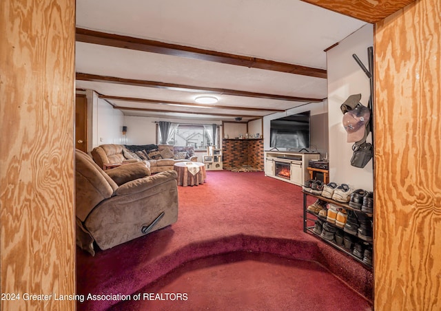 carpeted living room with beam ceiling