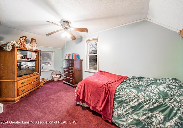 bedroom featuring ceiling fan, lofted ceiling, a textured ceiling, and carpet