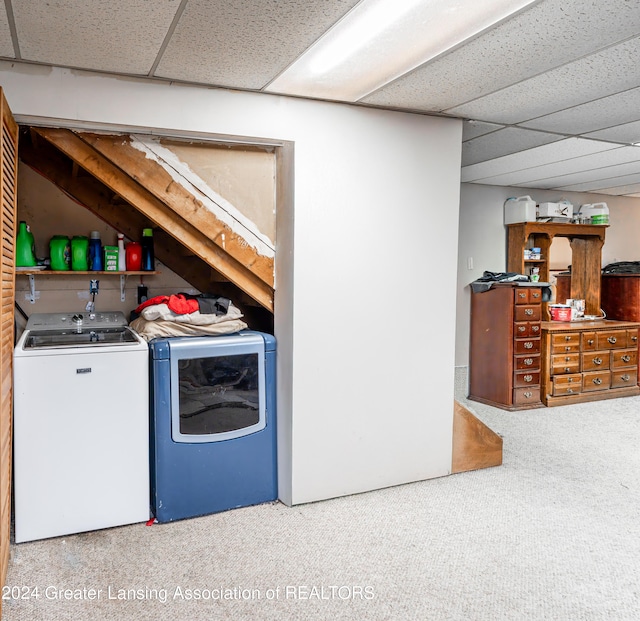 clothes washing area featuring washing machine and dryer and carpet flooring