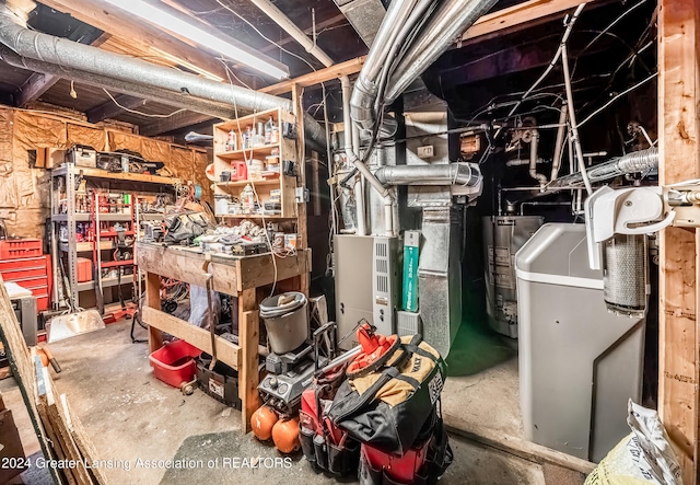 basement featuring gas water heater and a workshop area